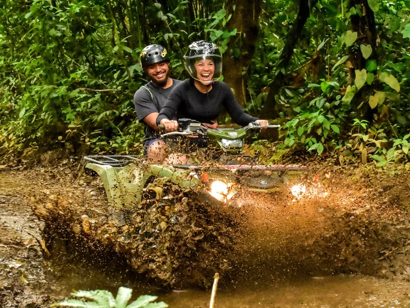 Couple enjoying an ATV ride through rainforest trails in La Fortuna.