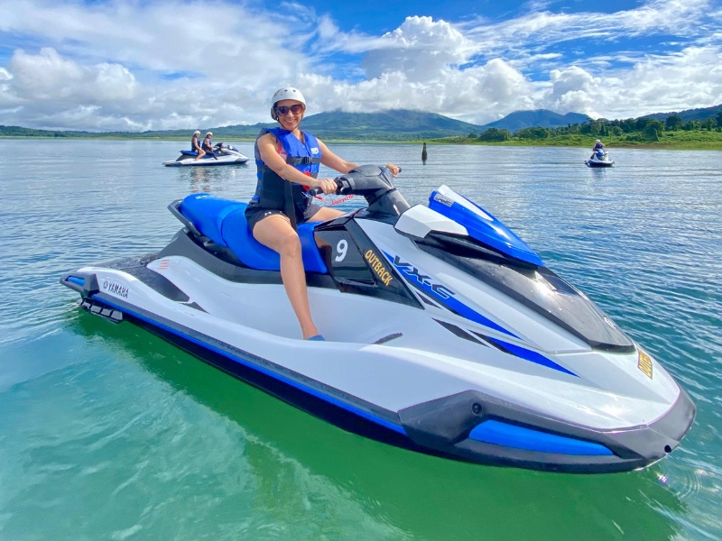 Woman riding a Yamaha Jet Ski on Arenal Lake in Costa Rica.