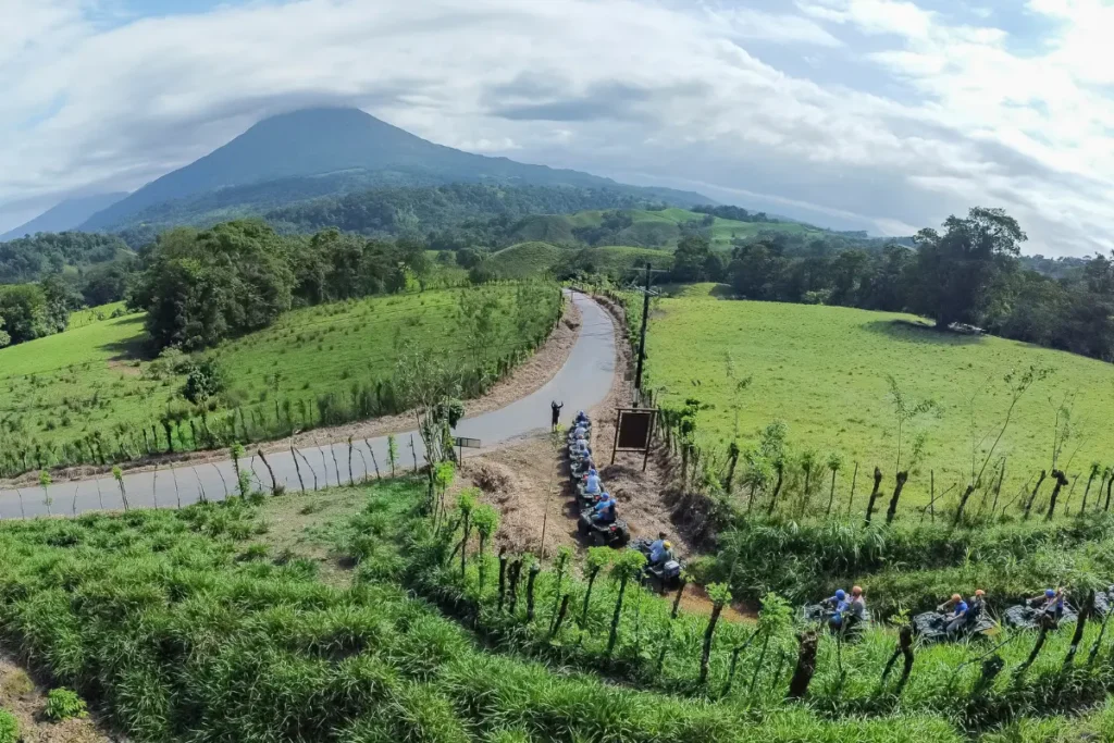 group riding ATVs with Arenal Volcano backdrop in La Fortuna Costa Rica