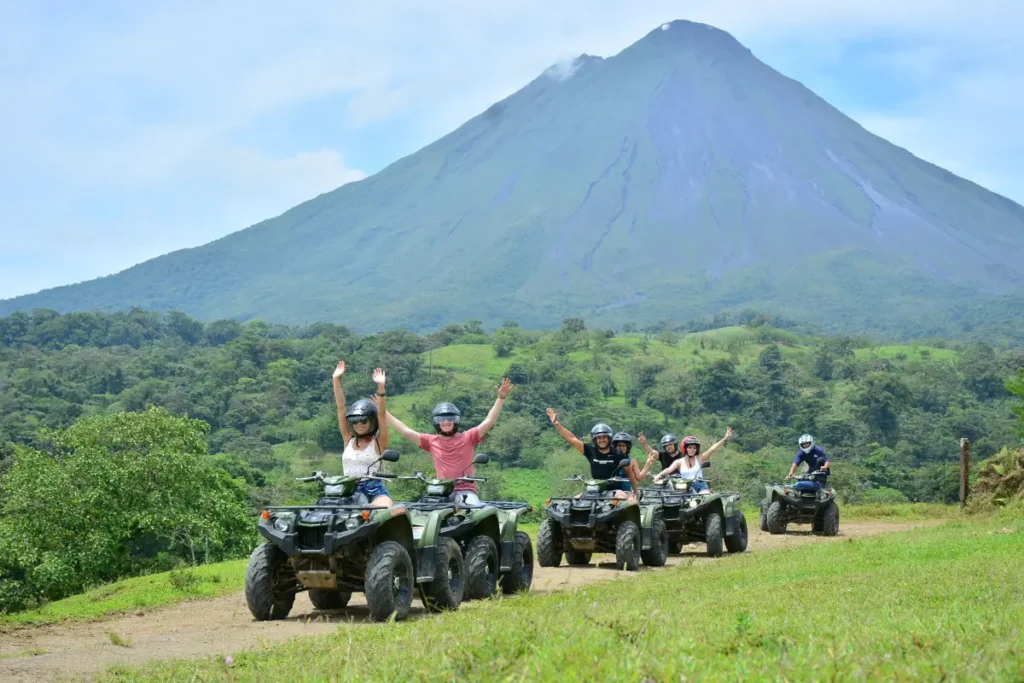 Group of travelers on ATVs enjoying volcano views during an Outback Quads adventure in La Fortuna Costa Rica.