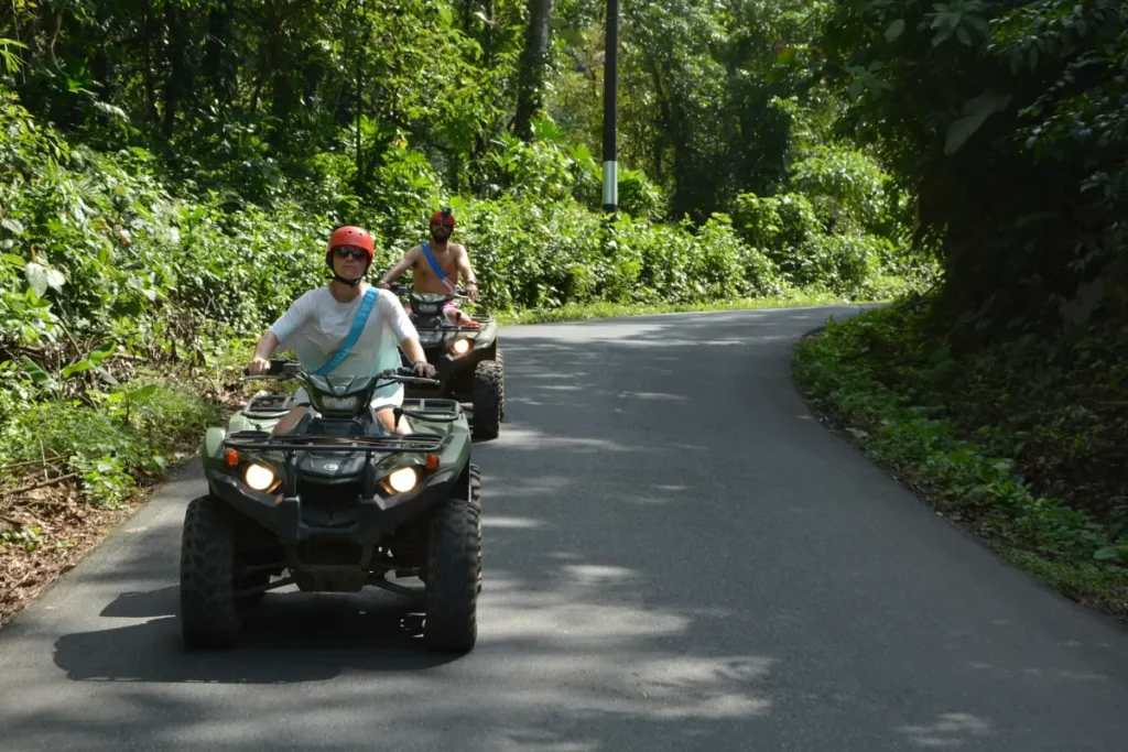 Travelers riding ATVs through scenic rainforest roads with Outback Quads in La Fortuna Costa Rica.