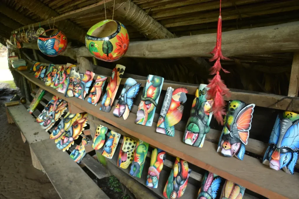 Handcrafted Maleku masks and wooden art displayed at a local artisan shop near La Fortuna Costa Rica.