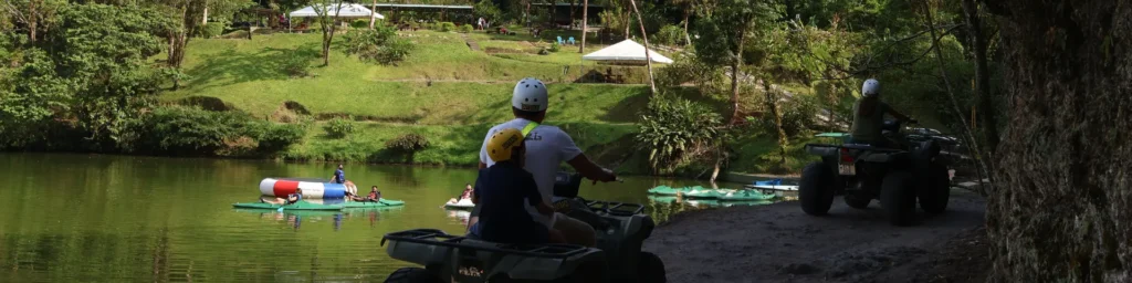Travelers riding ATVs near a scenic lake during a guided tour in La Fortuna, Costa Rica.