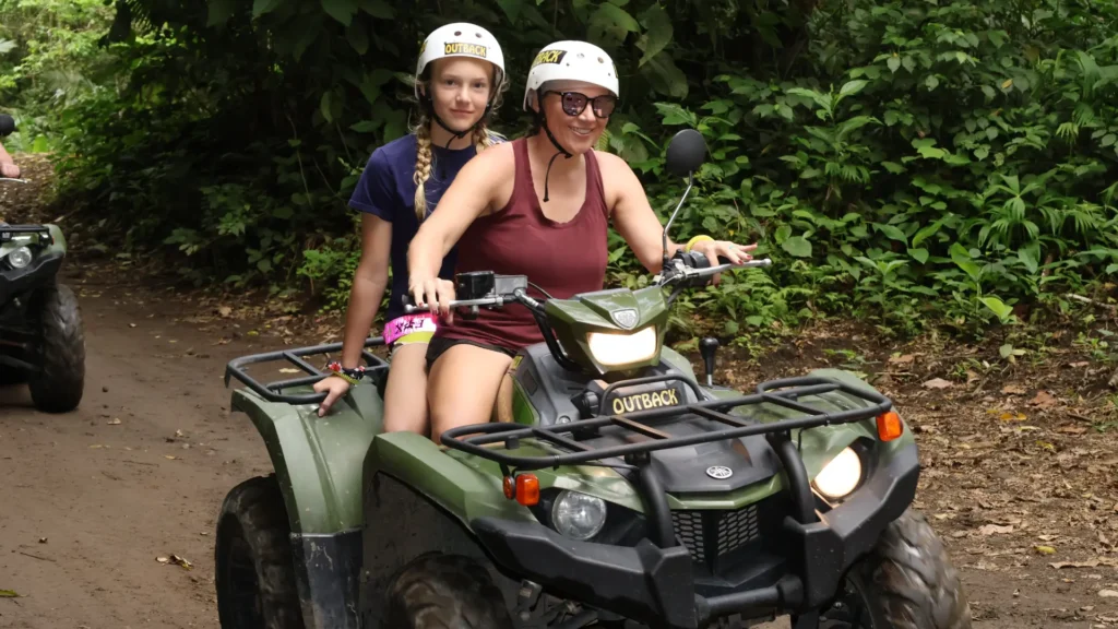 Mother and child riding a family-friendly ATV near Lake Arenal during the LakeSide & River Crossing ATV Tour