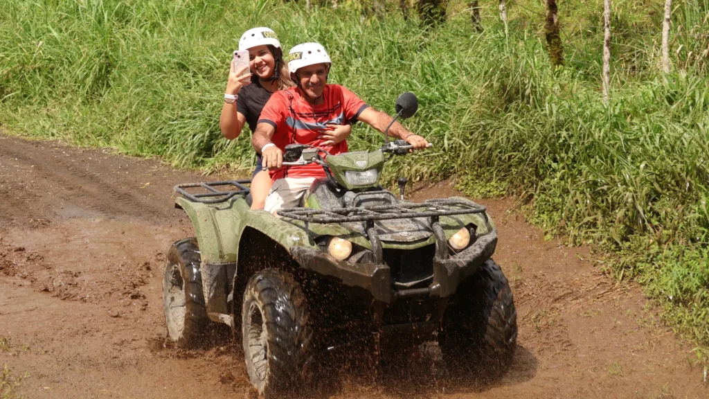 Couple riding an ATV along a rainforest trail in La Fortuna, Costa Rica